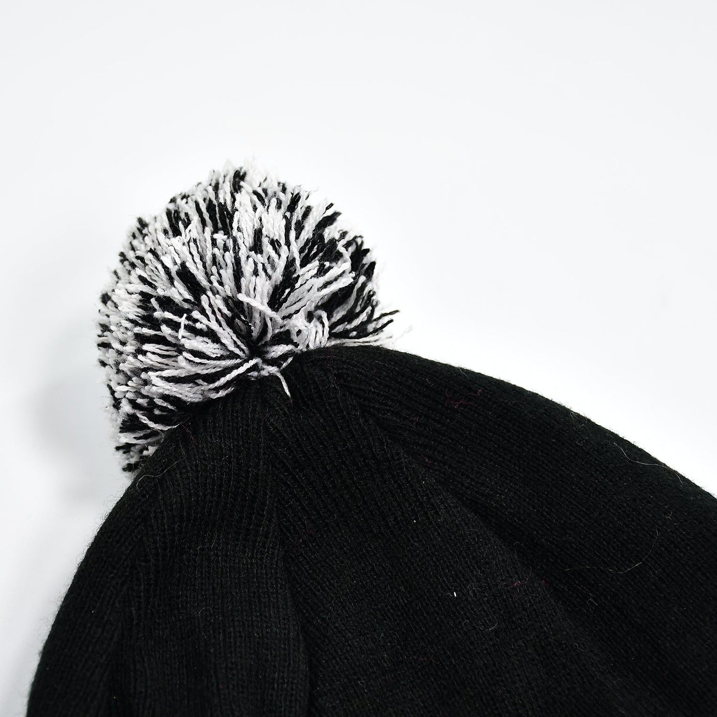 Woolen knitted beanie cap with skull pattern.