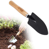 Hand trowel for digging, steel with black handle.